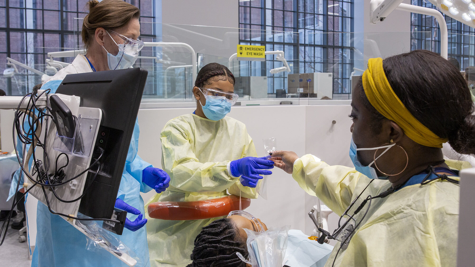 dental medicine with technicians handing off plastic bag