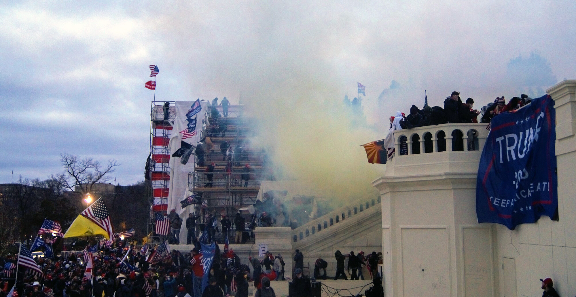 Angry mob on the steps of the U.S. Capitol with tear gas in the air.
