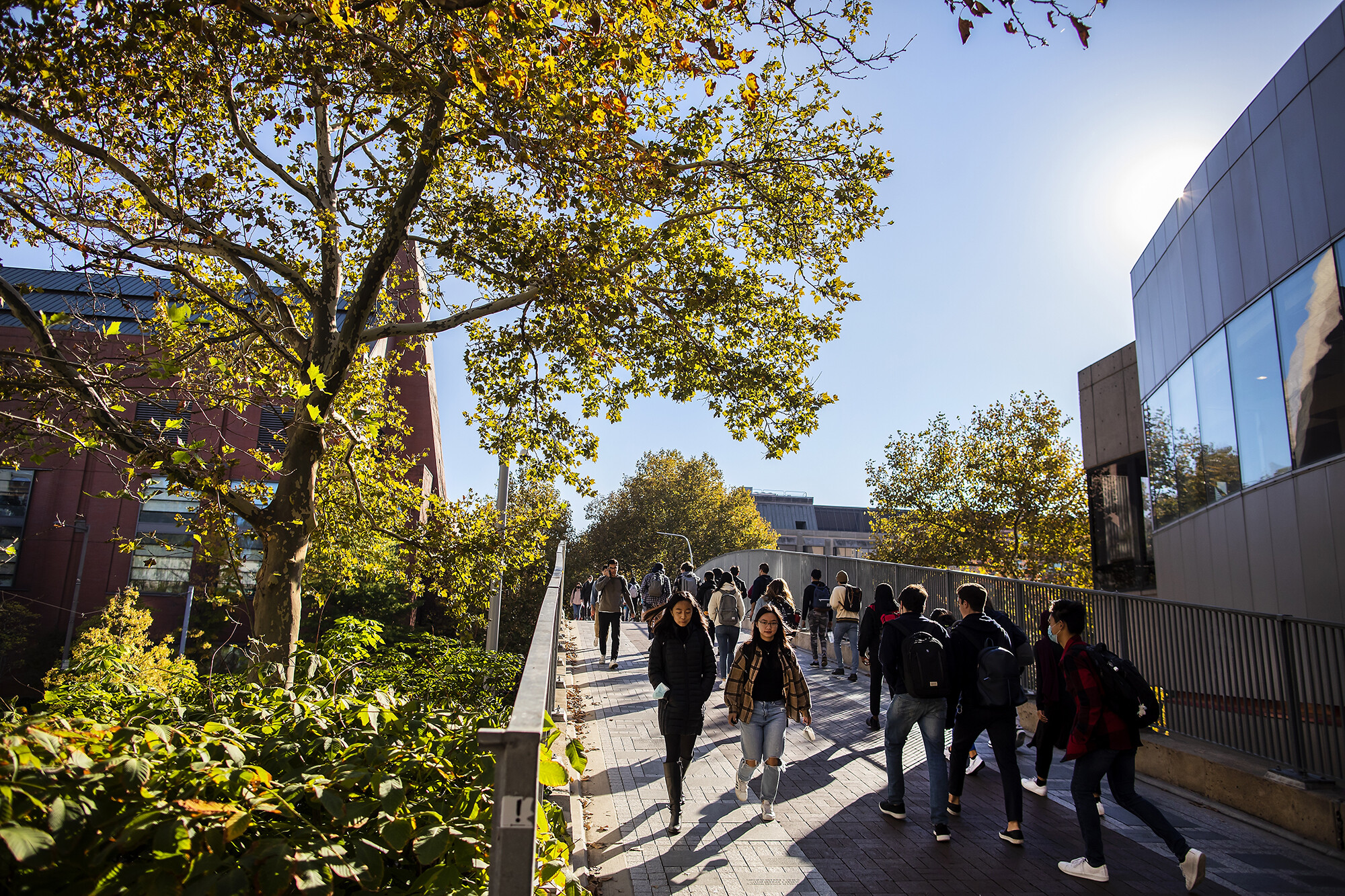 students walking over the 38th street bridge