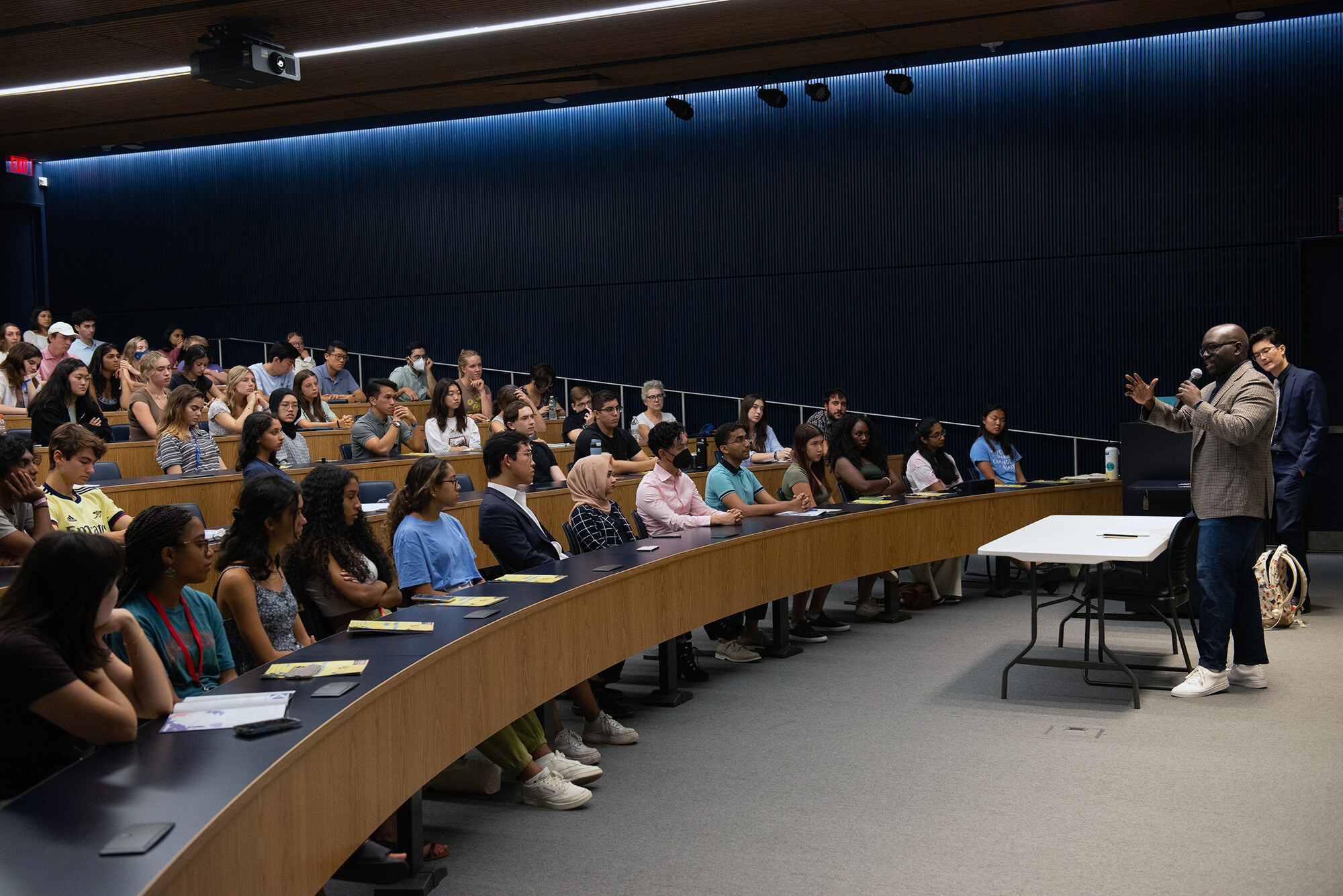 Jamelle Bouie speaks into a microphone in a lecture hall.
