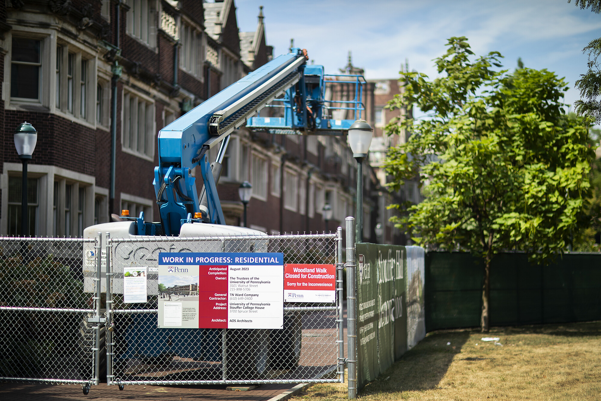 A fenced-in crane outside Stouffer Hall in Penn’s Quadrangle.