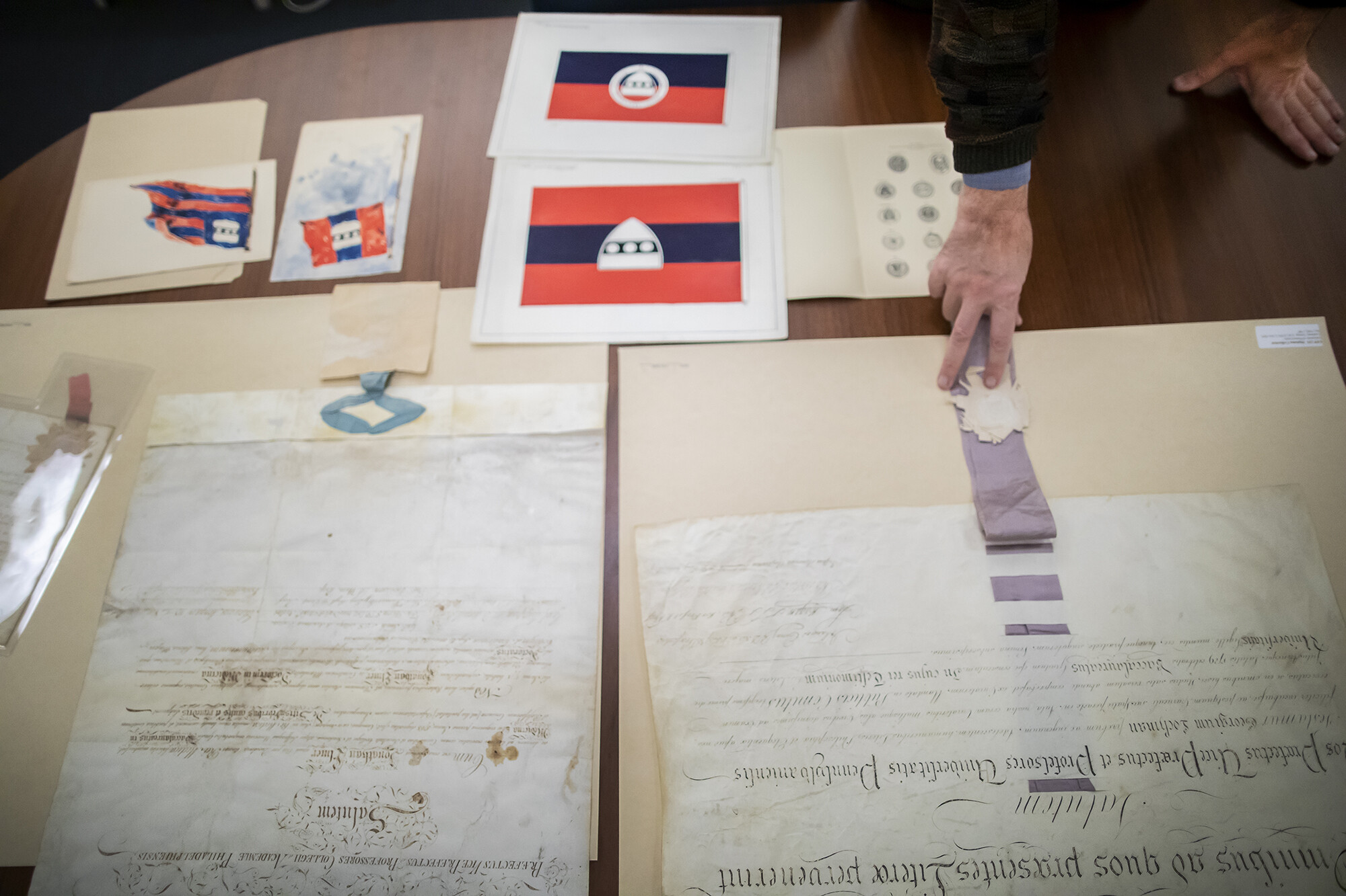 Archival parchments and ephemera from Archives on a table.
