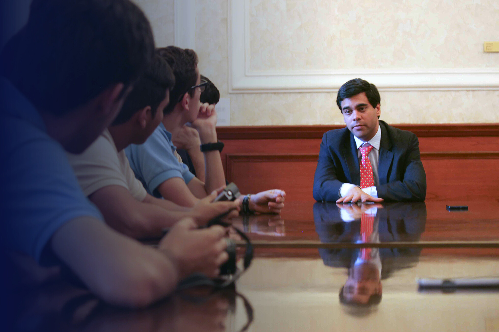angel alvarado speaking at a table