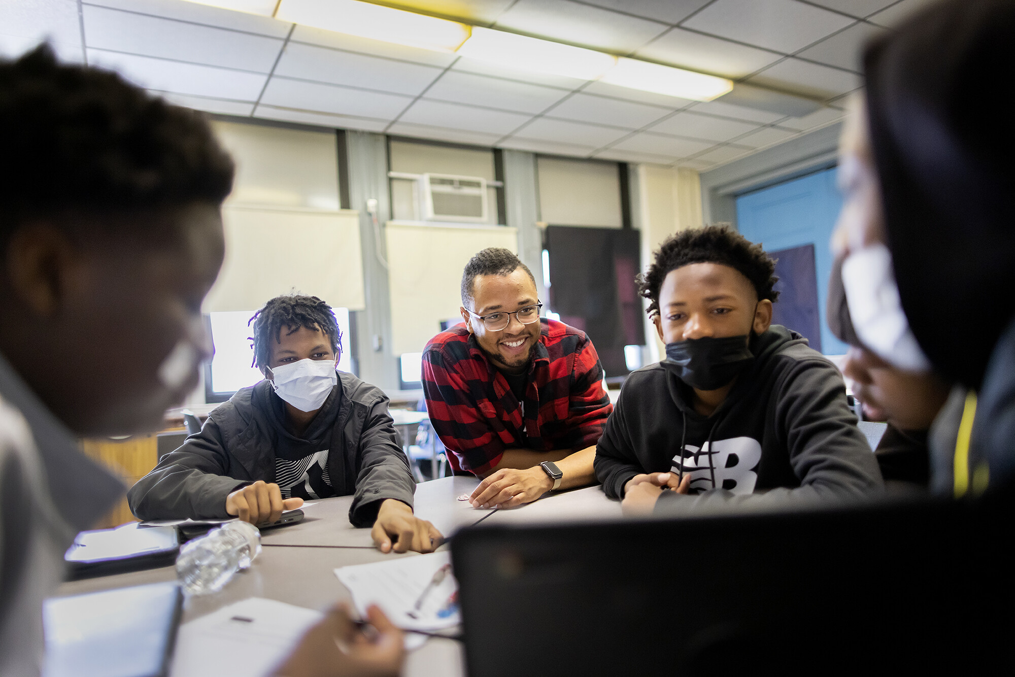 lea school teacher tamir harper with students at a table