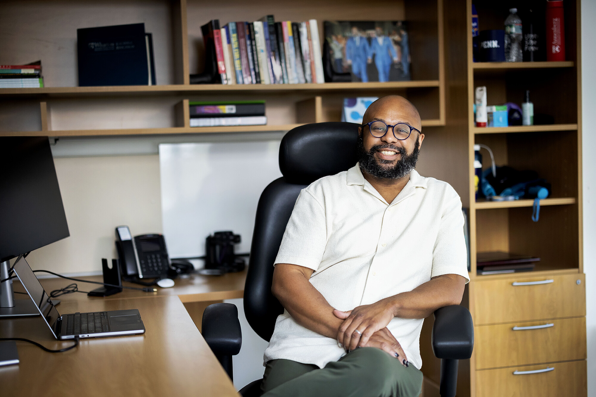 Desmond Patton seated at his desk