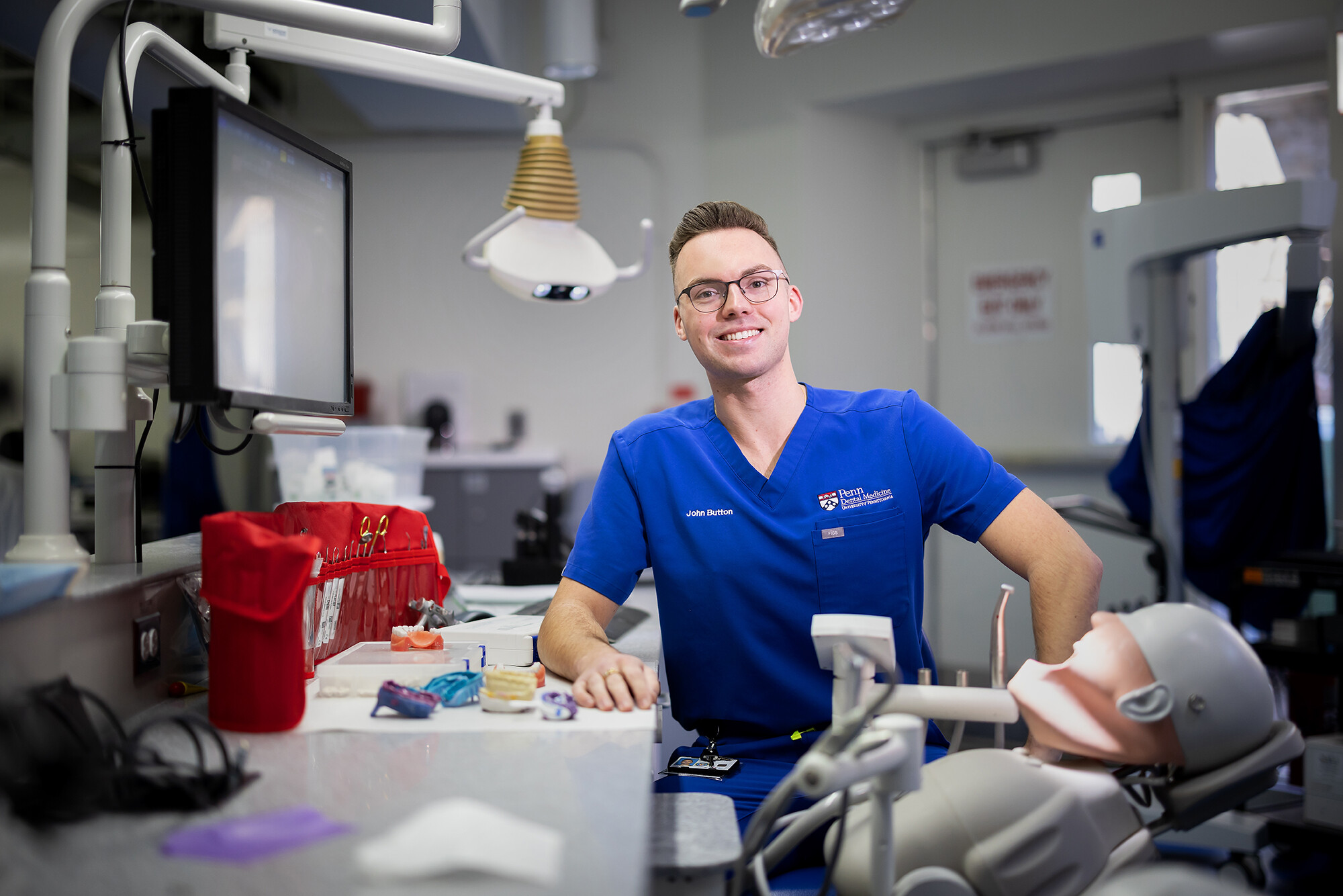 John Button poses in dental school lab.
