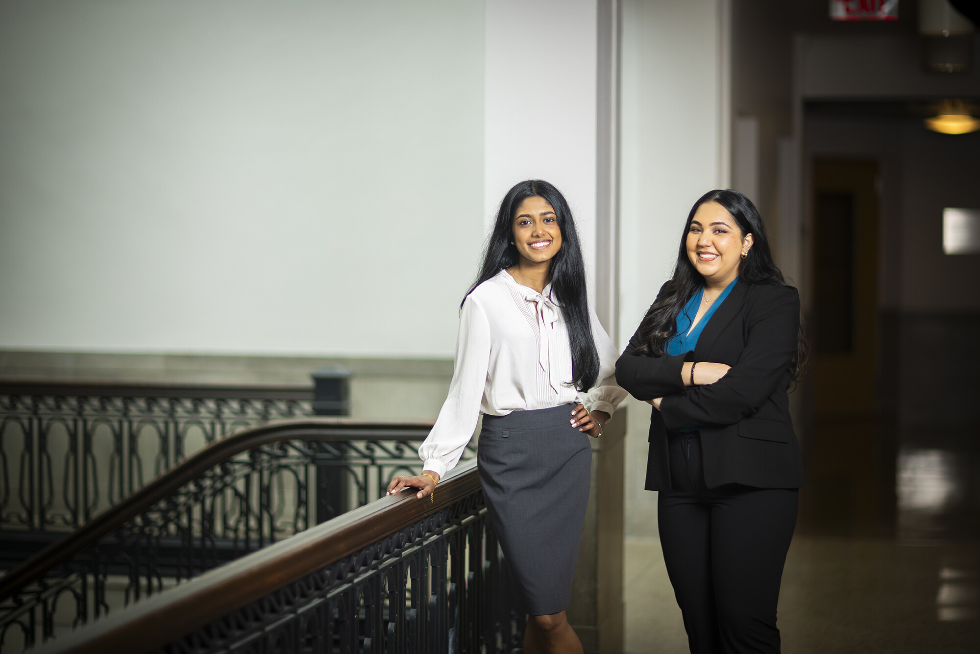 Penn fourth-years Gauthami Moorkanat on the left and Simran Rajpal stand in a hallway in Fisher-Bennett Hall on Penn campus.