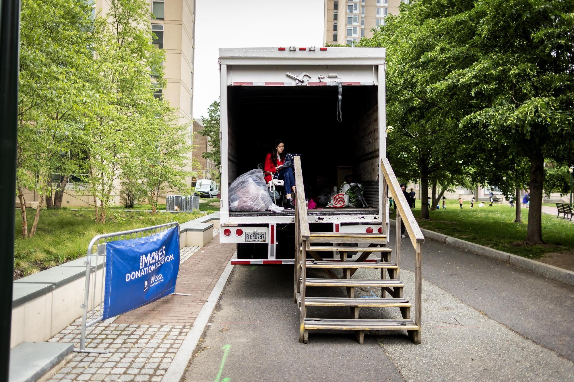 Student sits in truck for move-out donations.