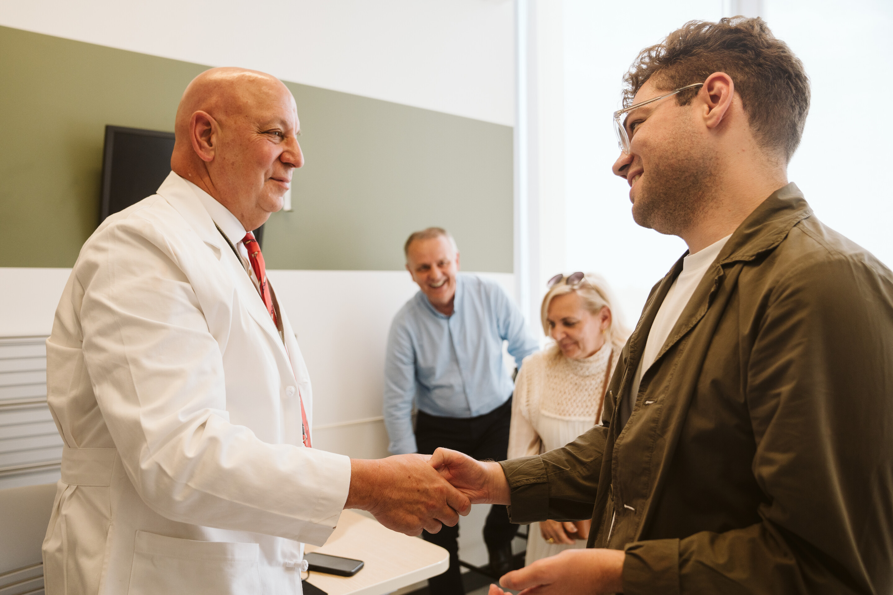 Luka Krizanac shakes Scott Levin’s hand.