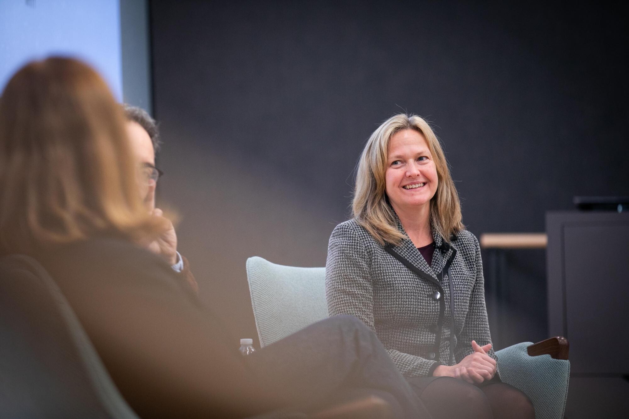 Kelly Jordan-Sciutto smiling at fellow panelists.