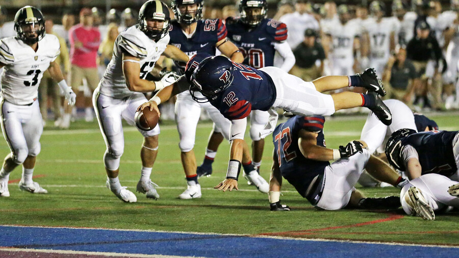 Eddie Jenkins of the sprint football team dives into the endzone with the ball against Army.