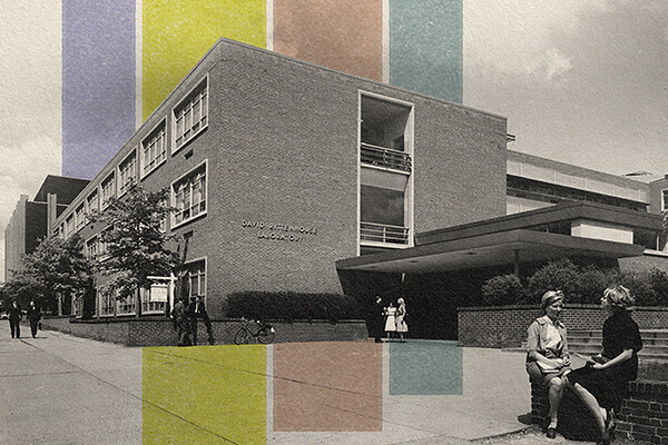 vintage photo of the facade of the David Rittenhouse Laboratory, two people seated on low wall in front of building.