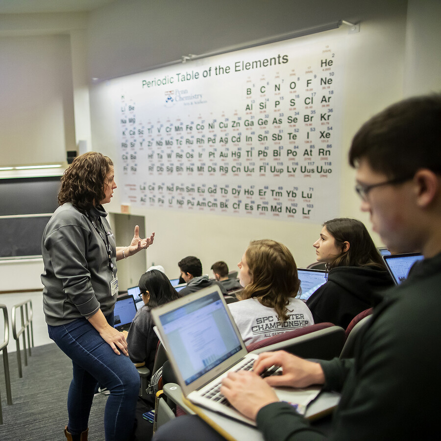 chemistry lecture hall with periodic table in background