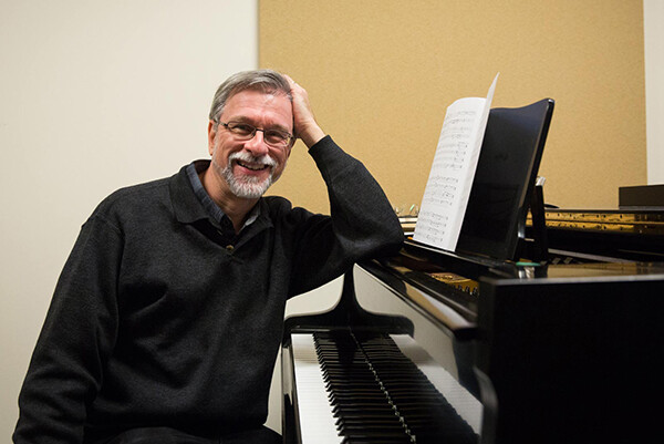 James Primosch seated at his piano.