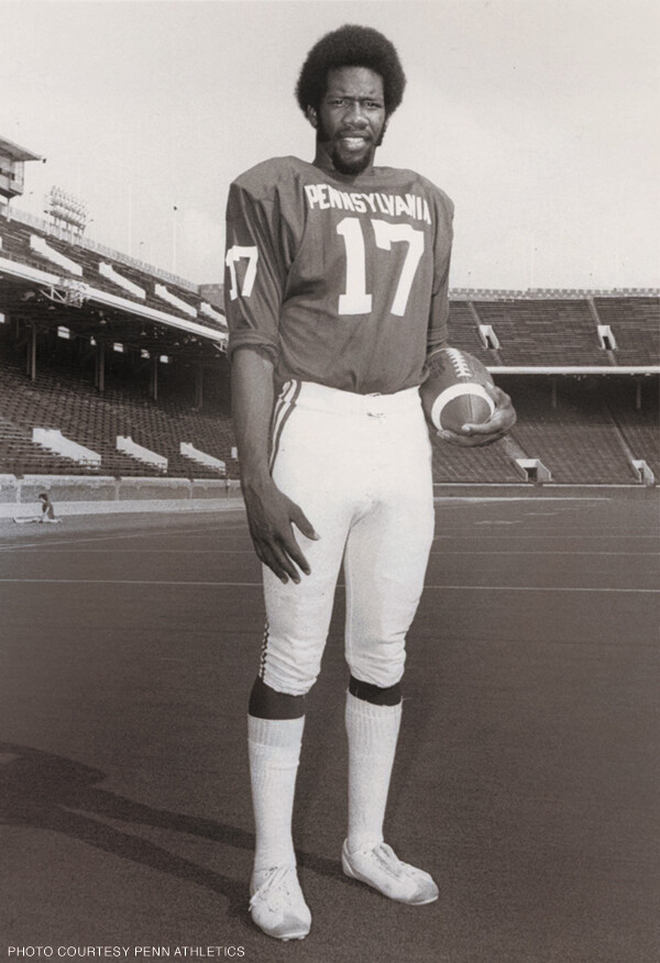 Marty Vaughn standing with a football on Franklin Field in 1974.