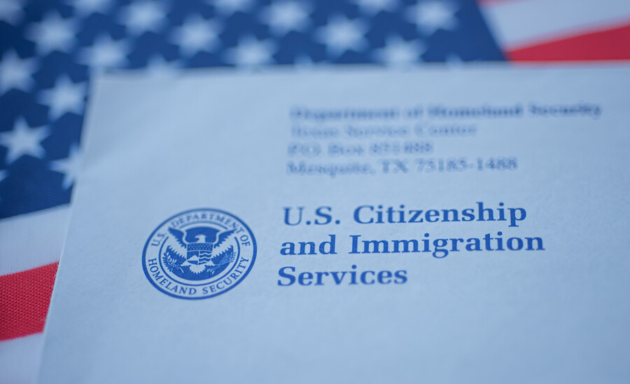 paperwork for citizenship and immigration with U.S. flag