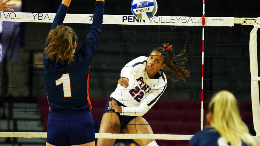 Autumn Leak strikes the ball over the net during a match.