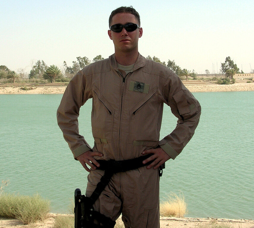 Jesse Hamilton in a military jumpsuit in front of a body of water in Bahria.