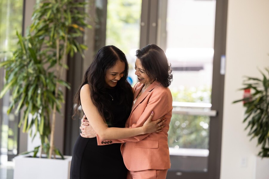 Inaya Zaman hugs a family member at the PIP/PEP luncheon.