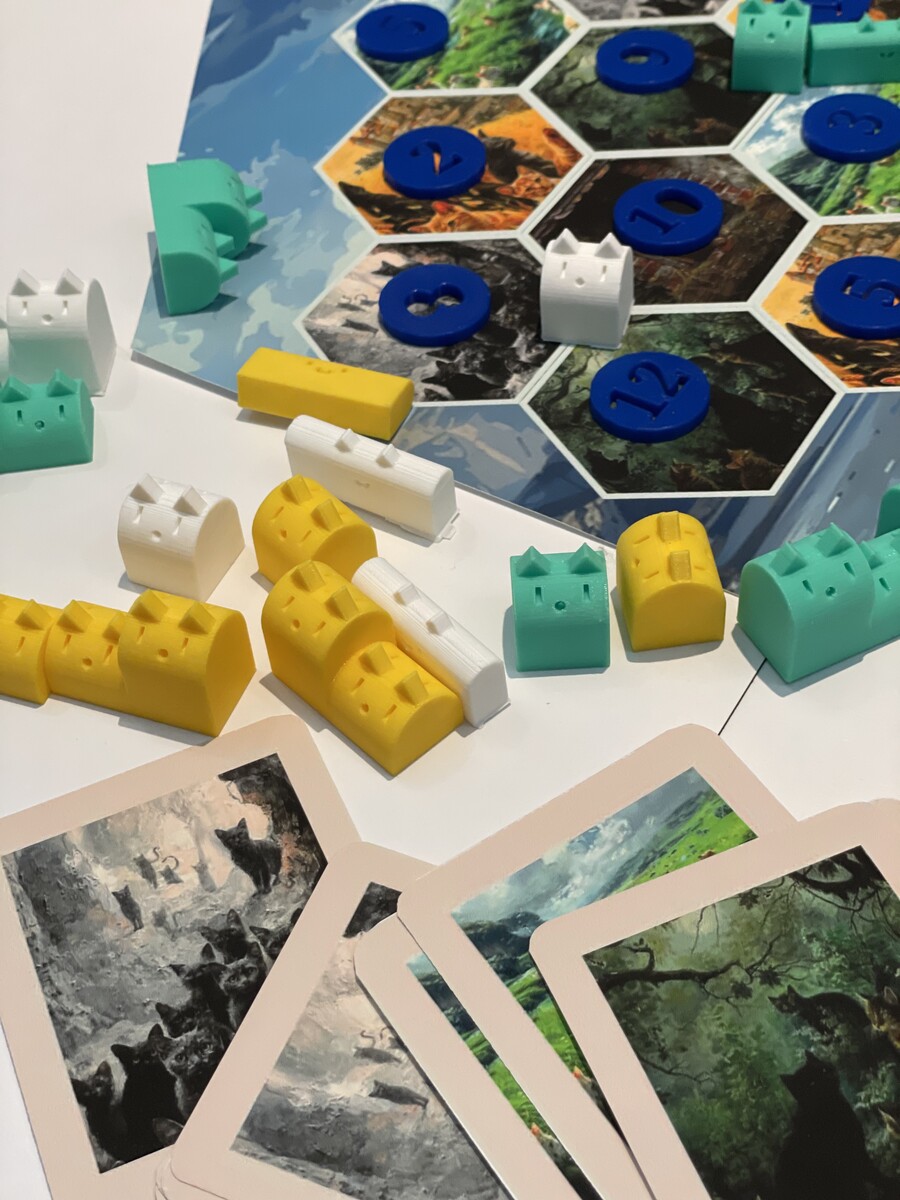Cat-inspired board game pieces on a table.