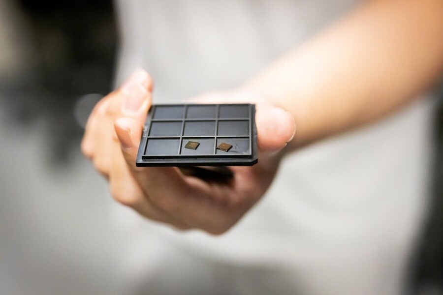 Researcher's hand holds a photonic crystal.