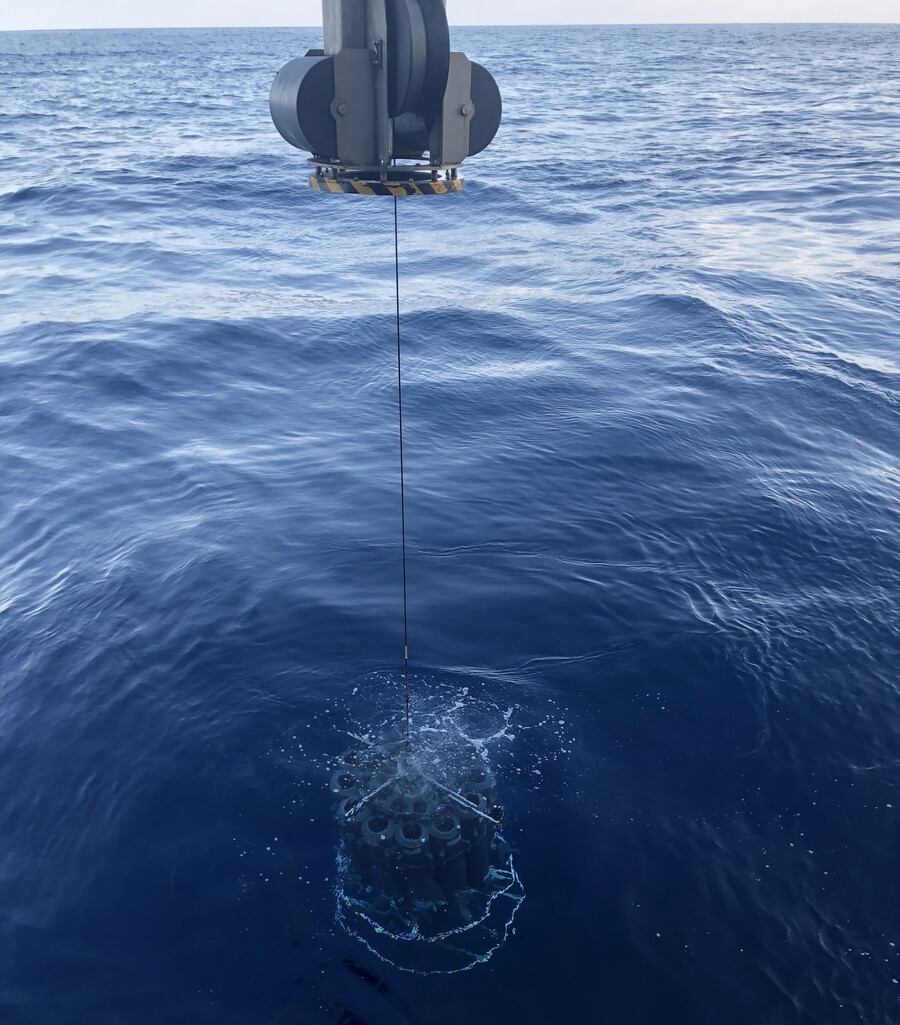 Large vials being dropped into the ocean.