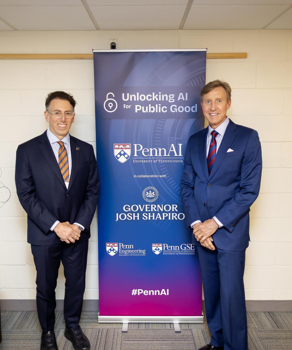 Pennsylvania’s Chief Transformation Officer Ben Kirshner and Penn President J. Larry Jameson in front of a banner that reads “Unlocking AI for Public Good.”