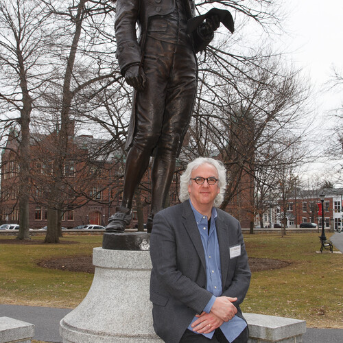 Stephen Rush next to statue