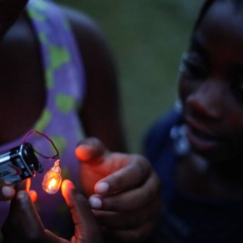 Young person touching battery light