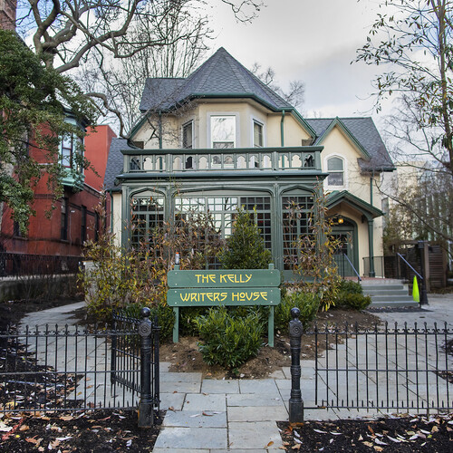 A yellow and green victorian house