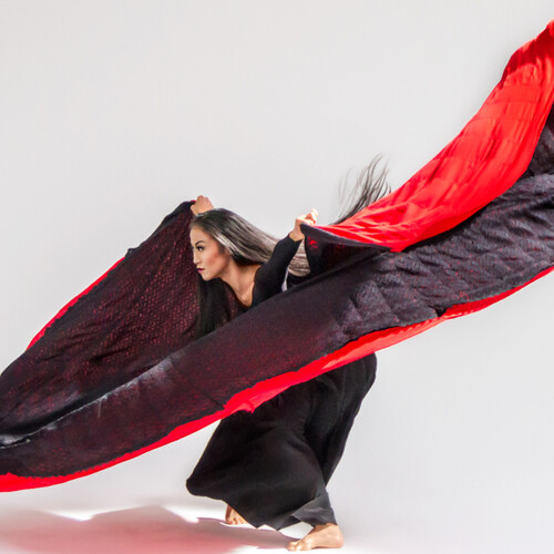 Martha Graham dancer with wide red tapestry