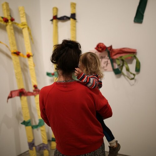 An infant and her mother in an art gallery