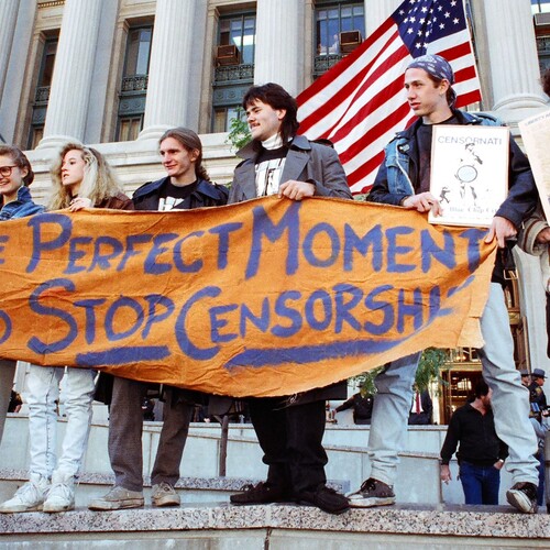 Group of protesters on steps with sign that reads The Perfect Moment to Stop Censorship