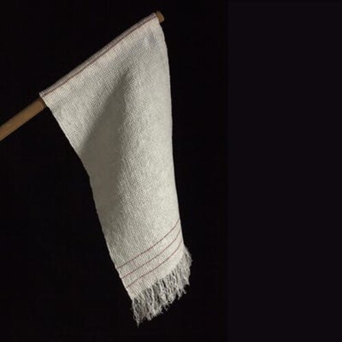 White flag with three lines and fringe that span its end