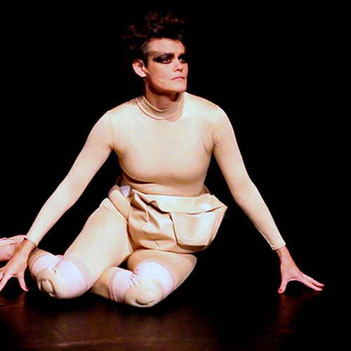 Person on floor in tights with painted toenails and fanny pack