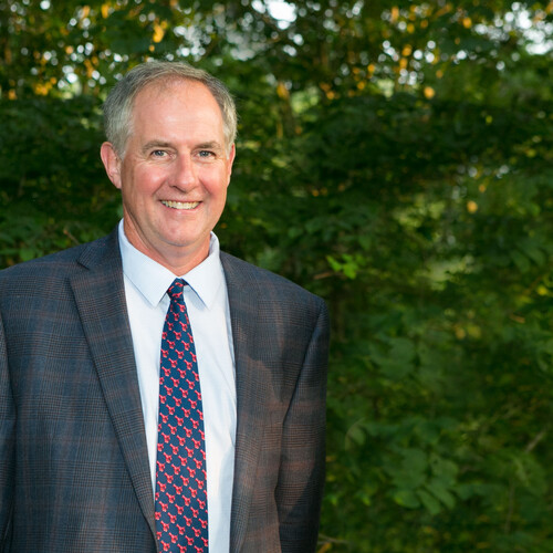 Bill Cullina smiles in front of trees