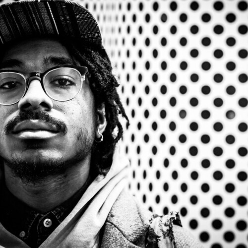Joel Ross with black and white polka dot background