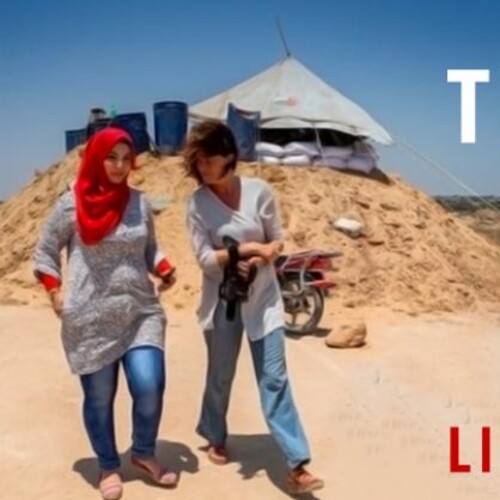 Two people walking in the desert