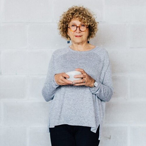 Merry White holding a Japanese ceramics. 