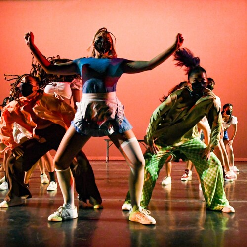 Onda Latina group animatedly performs on stage