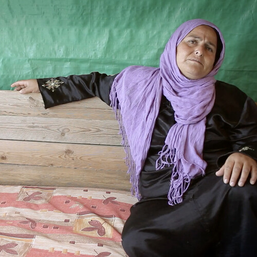 A sitting Bedouin woman