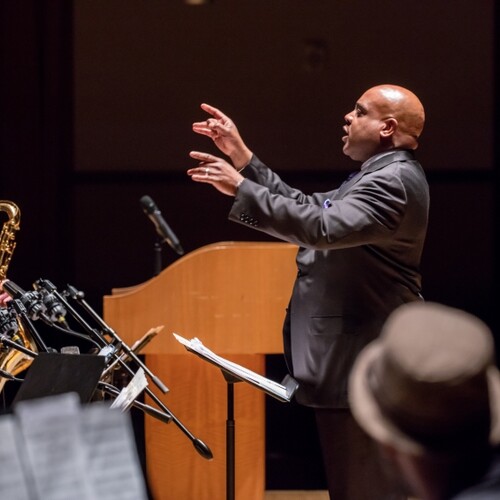 Conductor conducting a symphony. 