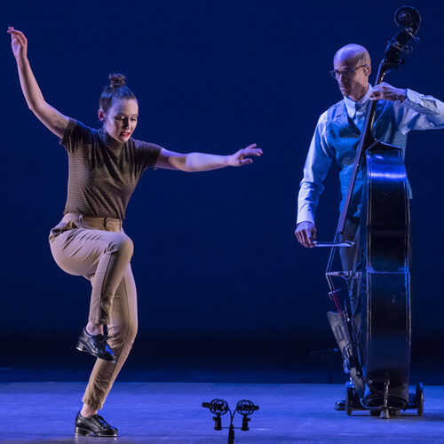 Tap dancer on stage with a cellist 