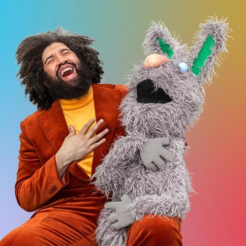 Jayson Musson laughing with puppet