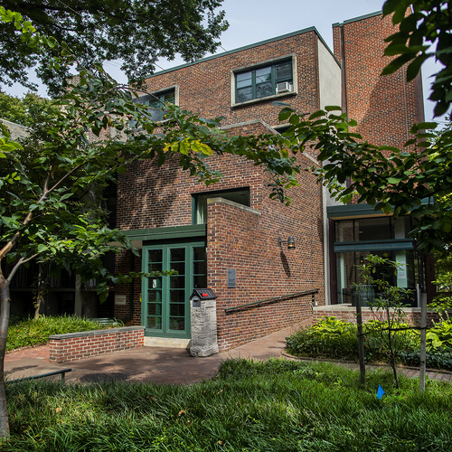 Penn Grad Center brick exterior with foliage