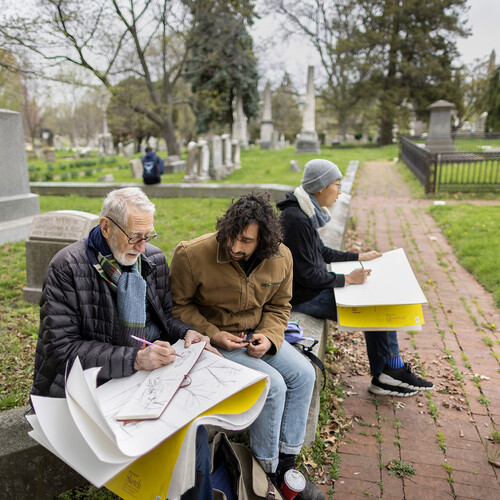 Laurie Olin and two students seated at Woodlands Cemetery with drawing supplies.