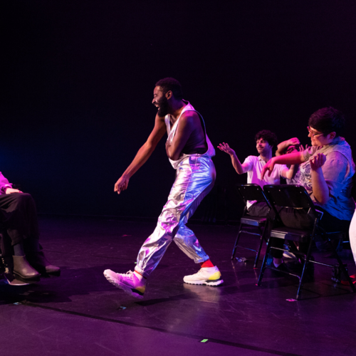 Jerron Herman dances in white and metallic outfit.