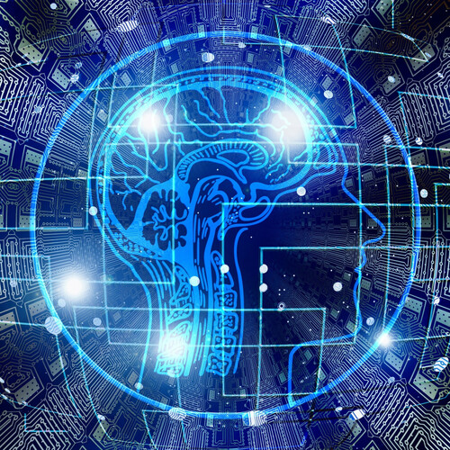 Abstract scan of brain overlapping a computer chip network.