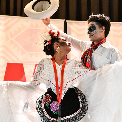 People dressed in festive Mexican apparel.