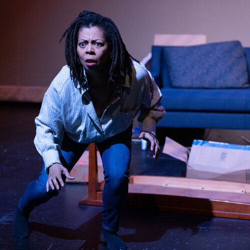 Actor on stage staring ahead concernedly. 